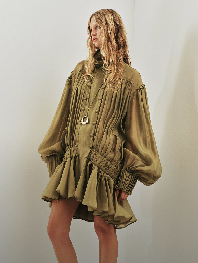 Aje editorial image of an olive dress with gathered fabric